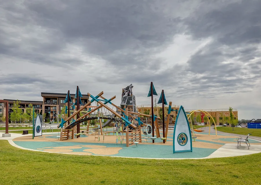 Aerial view of Wolf Willow roundabout on 194th avenue featuring Blue Devil Golf Course, Wolf Willow homes, and the scenic Fish Creek Park.