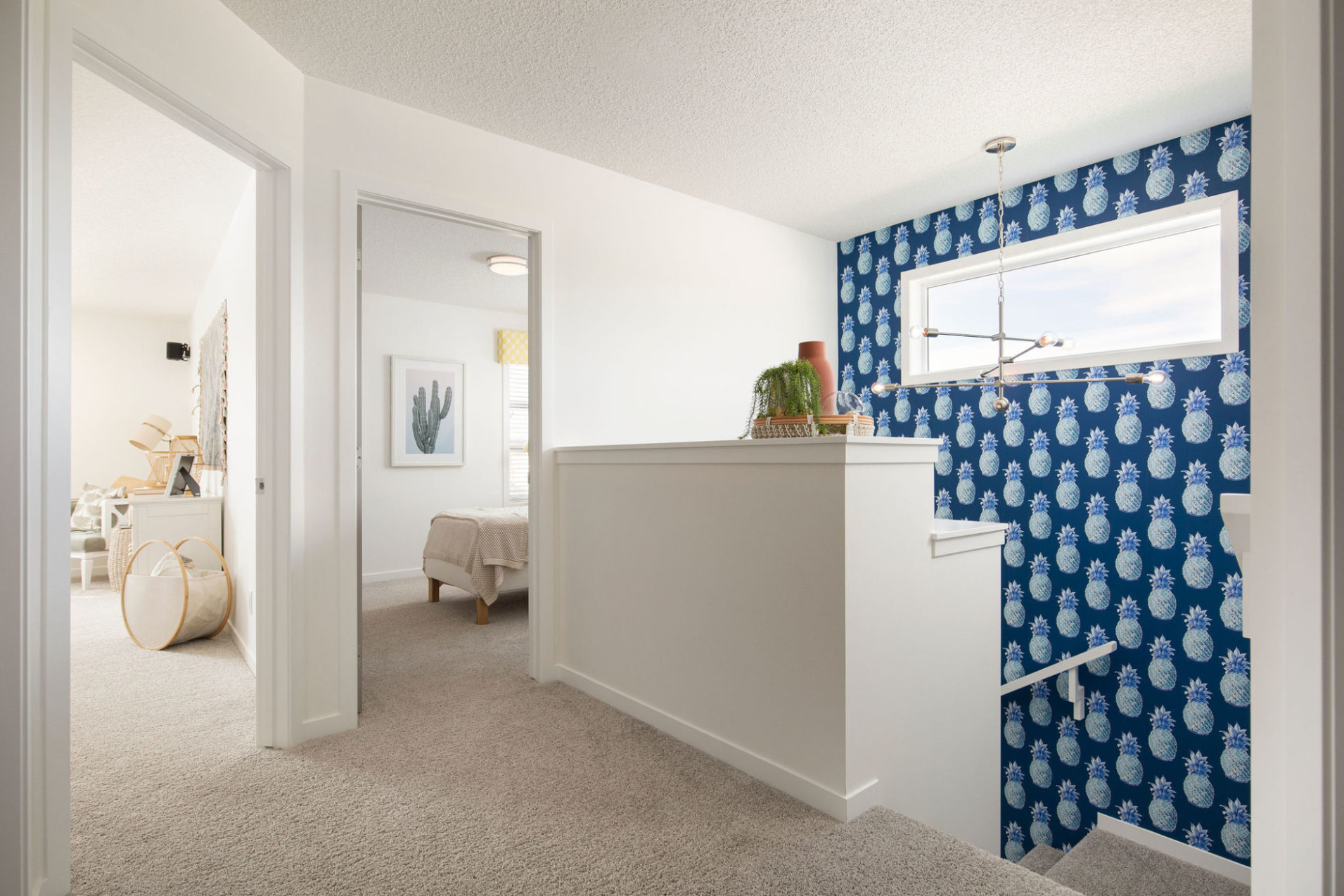 The upstairs landing with 2 bedrooms and pineapple patterned wallpaper.