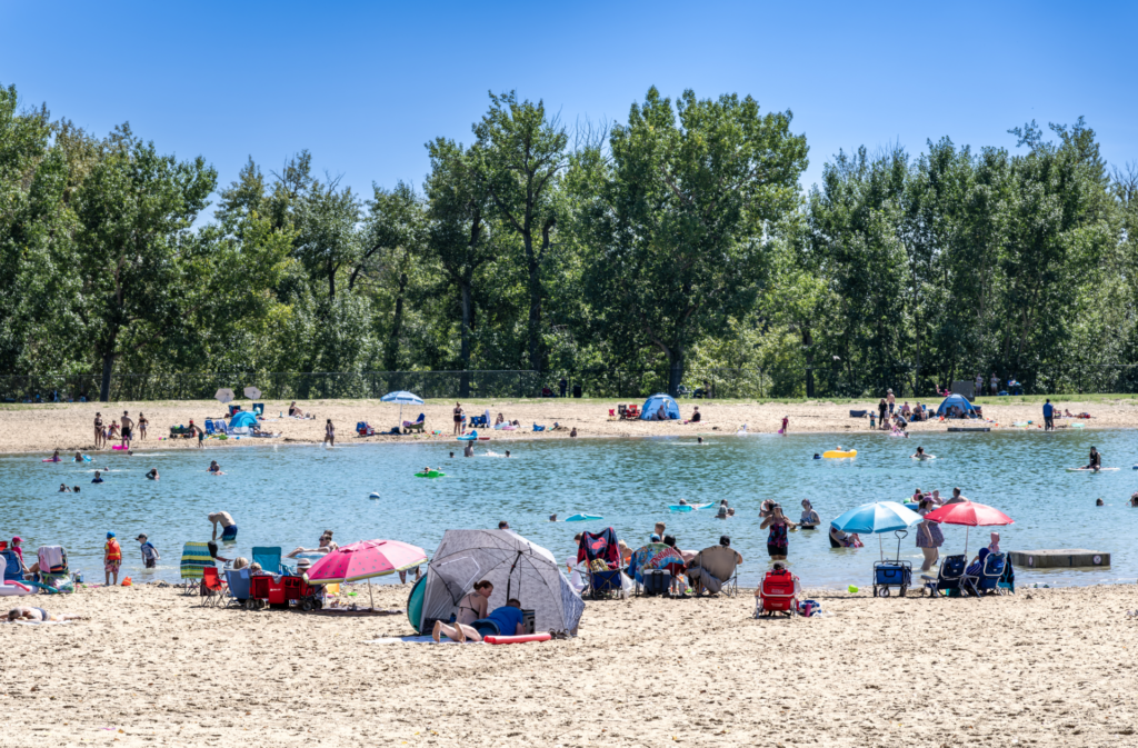 Beach-goers at Sikome Laker near Wolf Willow in south Calgary