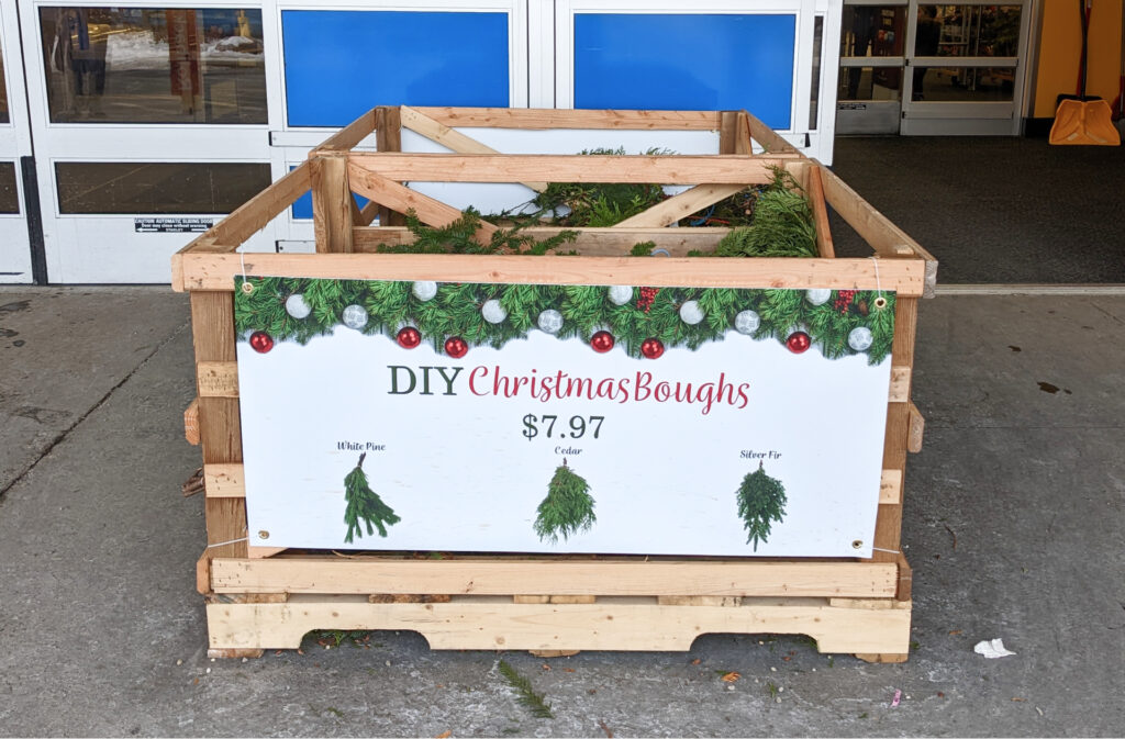 crate of diy christmas boughs outside a popular retailer