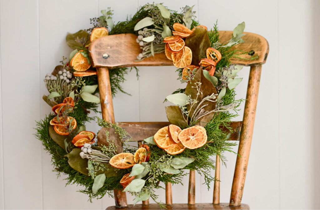homemade dried orange wreath hanging on an old antique dining room chair