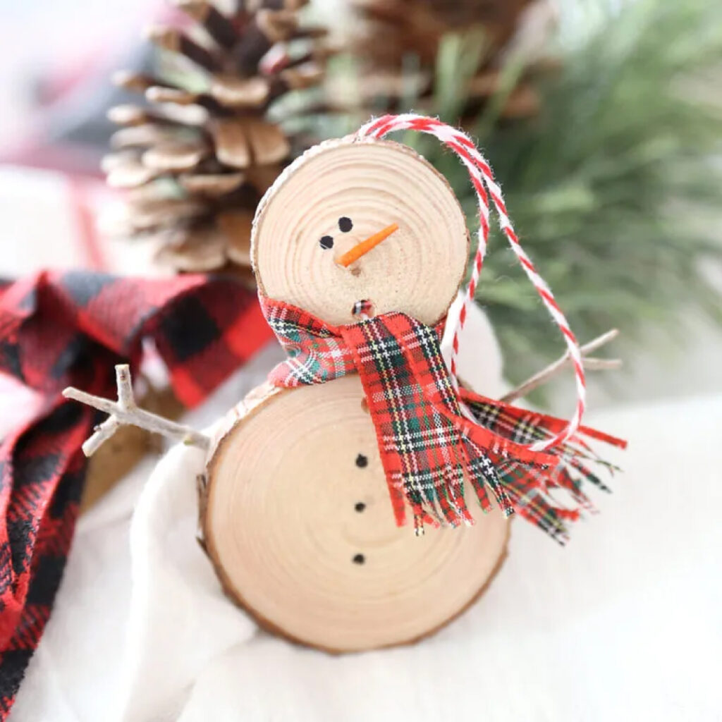 snowman decoration made from wood slices and ribbon