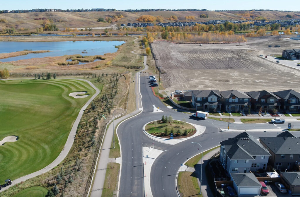 Drone view of Wolf Willow on the right, the Blue Devil golf course on the left, and the Bow River in the background