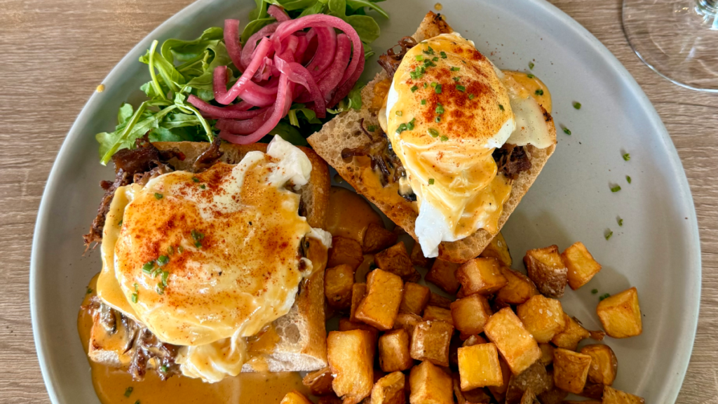 Eggs Benedict on artisan sourdough bread representing a dish at Monki Breakfast Club & Bistro Seton, a popular brunch restaurant in South Calgary